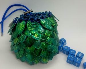 Green and blue anodized aluminum dragon scale dice bag with blue dice
